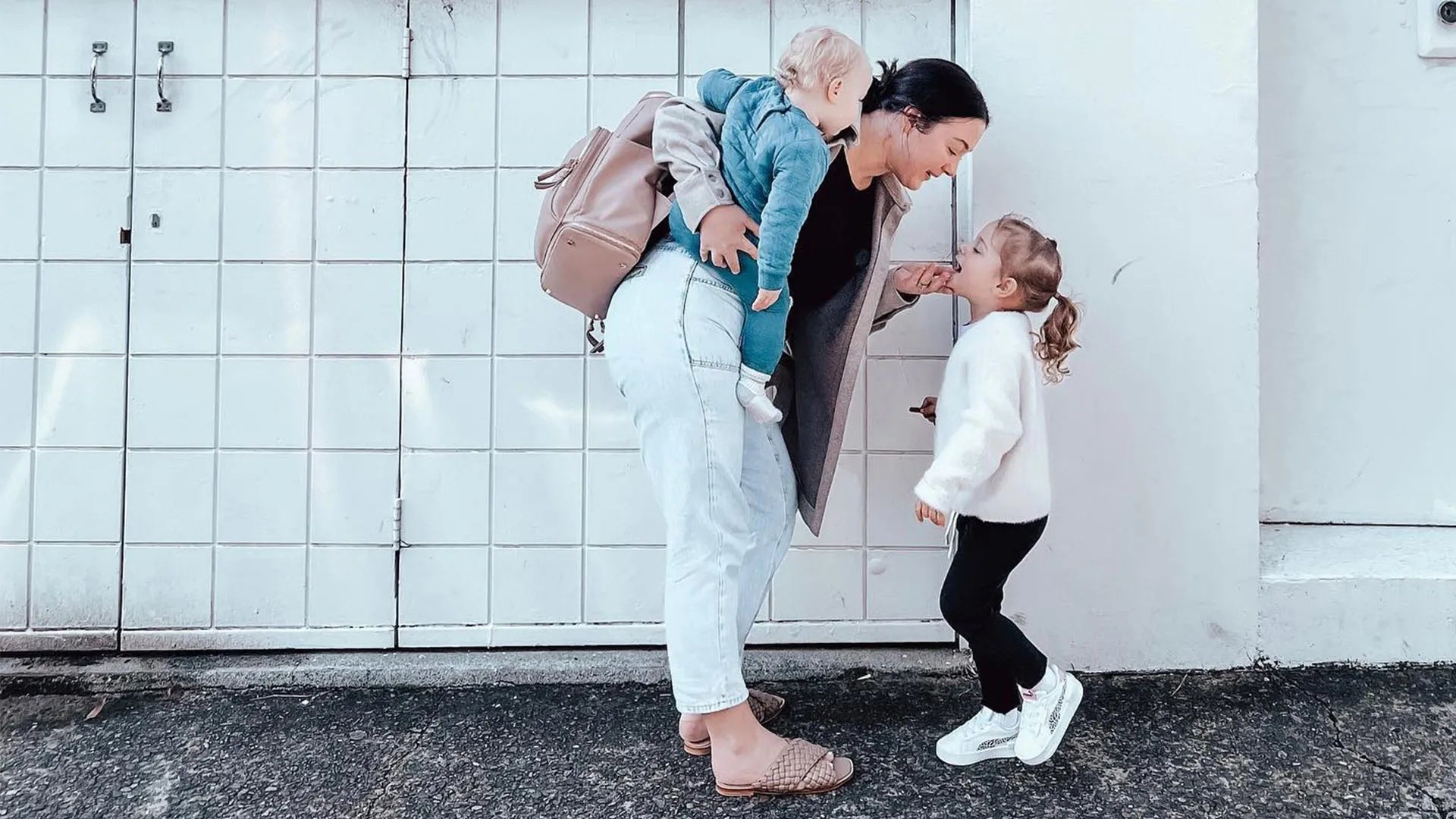 Parent with Tottie Nappy Backpack – hands-free parenting with two kids