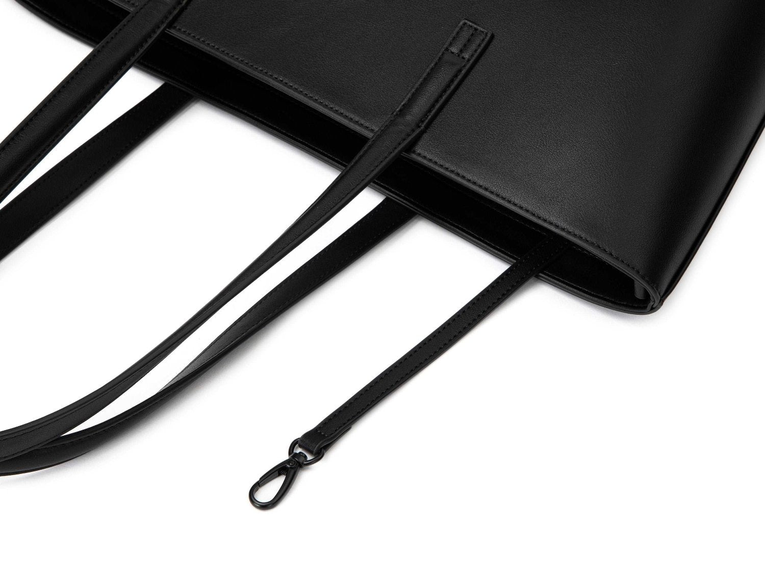 A black leather tote bag on white background