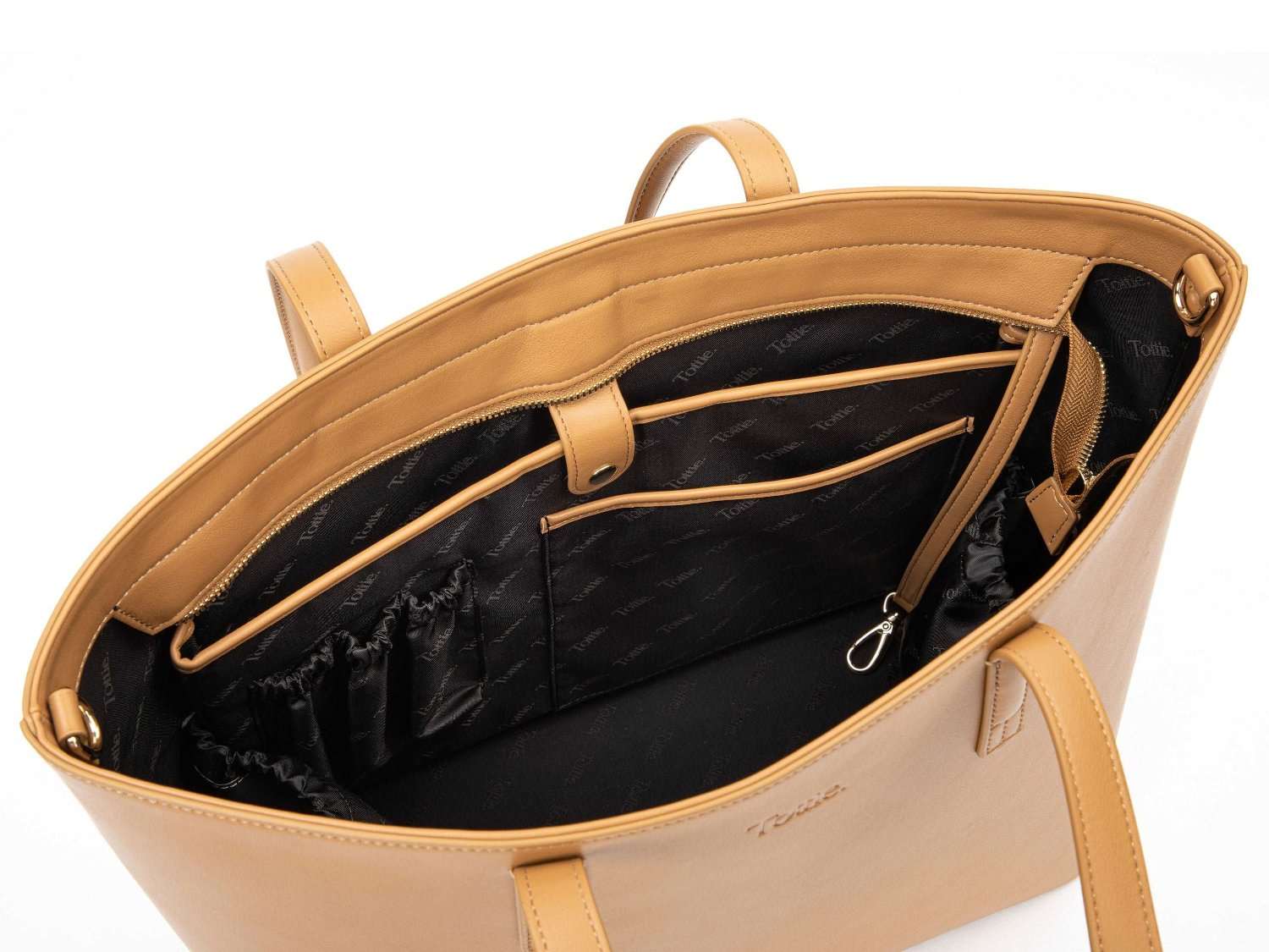 unzipped tan colour leather tote bag on white background