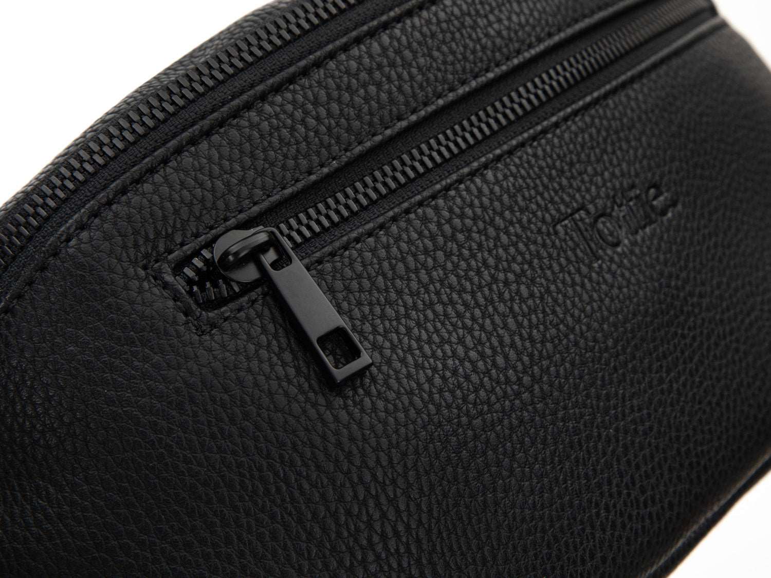 A Bum Bag in black leather with black hardware with Tottie marking on white background