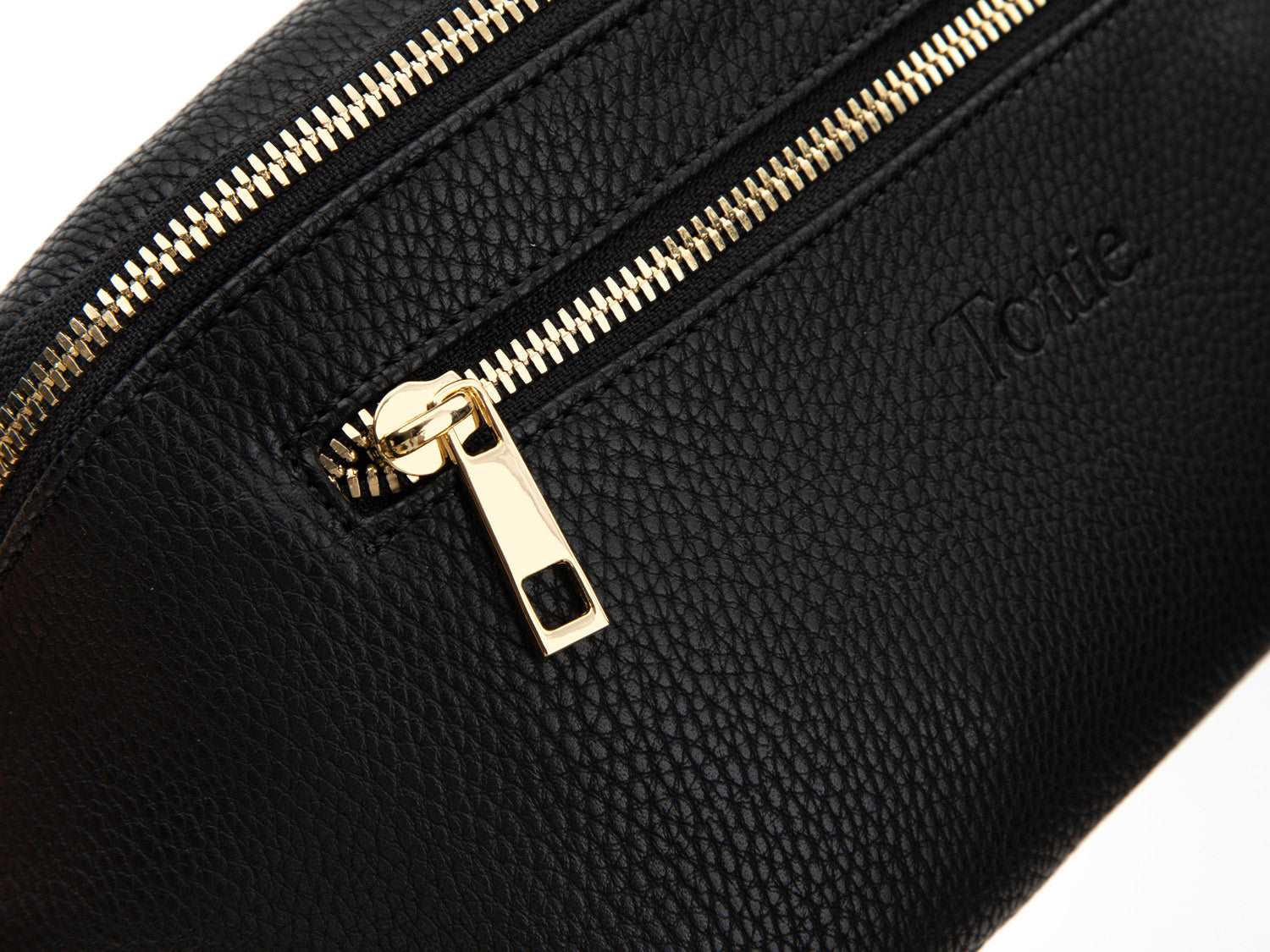 A Bum Bag in black leather with gold hardware on white background