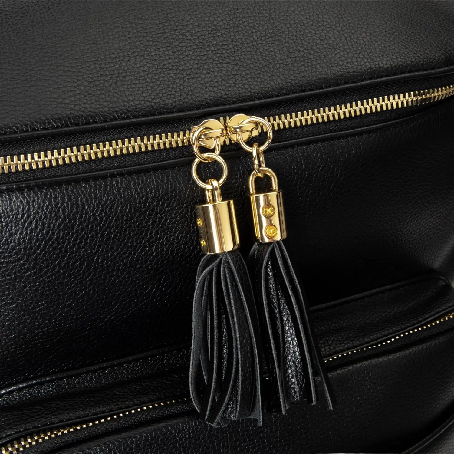 Close-up of gold tassel detail on black nappy bag backpack – elegant accessory accent.