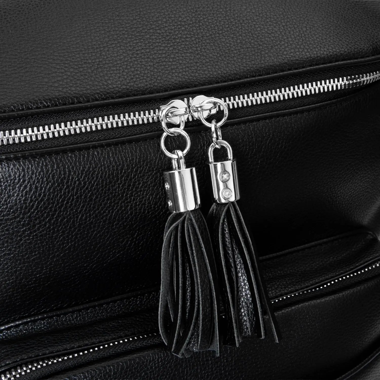 Tassel on black nappy bag backpack with silver hardware – close-up of decorative and functional detail.