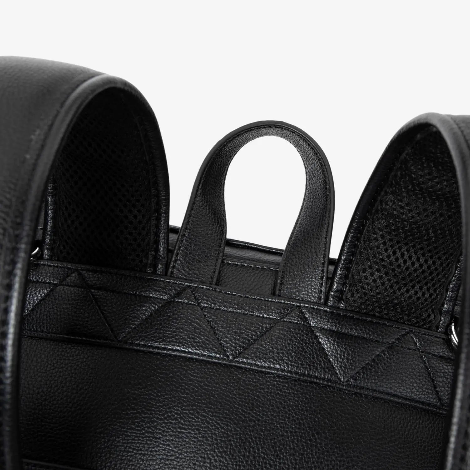 Close-up of grab handle on black nappy bag backpack – sturdy and easy to carry design.