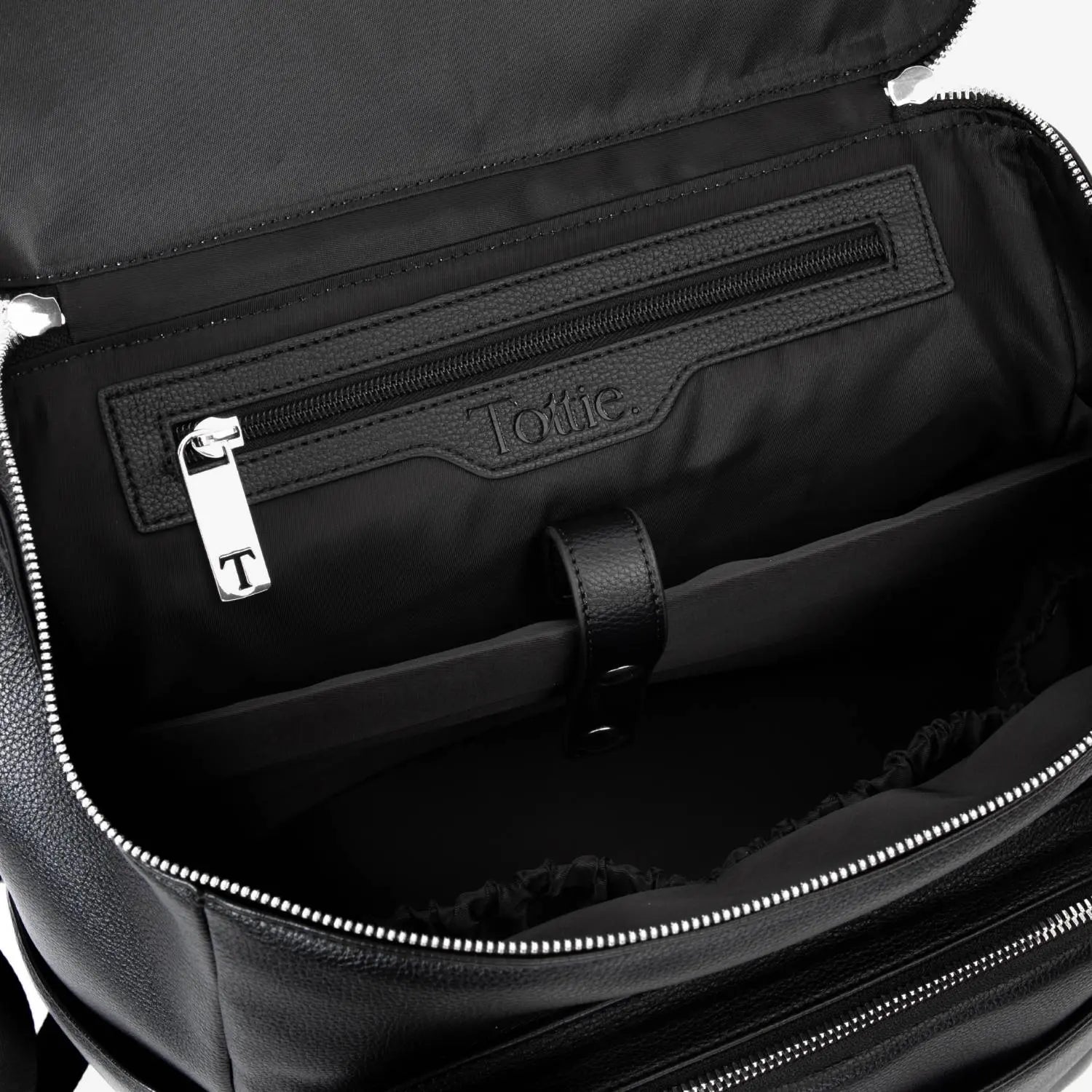 Open black nappy bag backpack shown from above with silver hardware – easy access to multiple storage pockets.