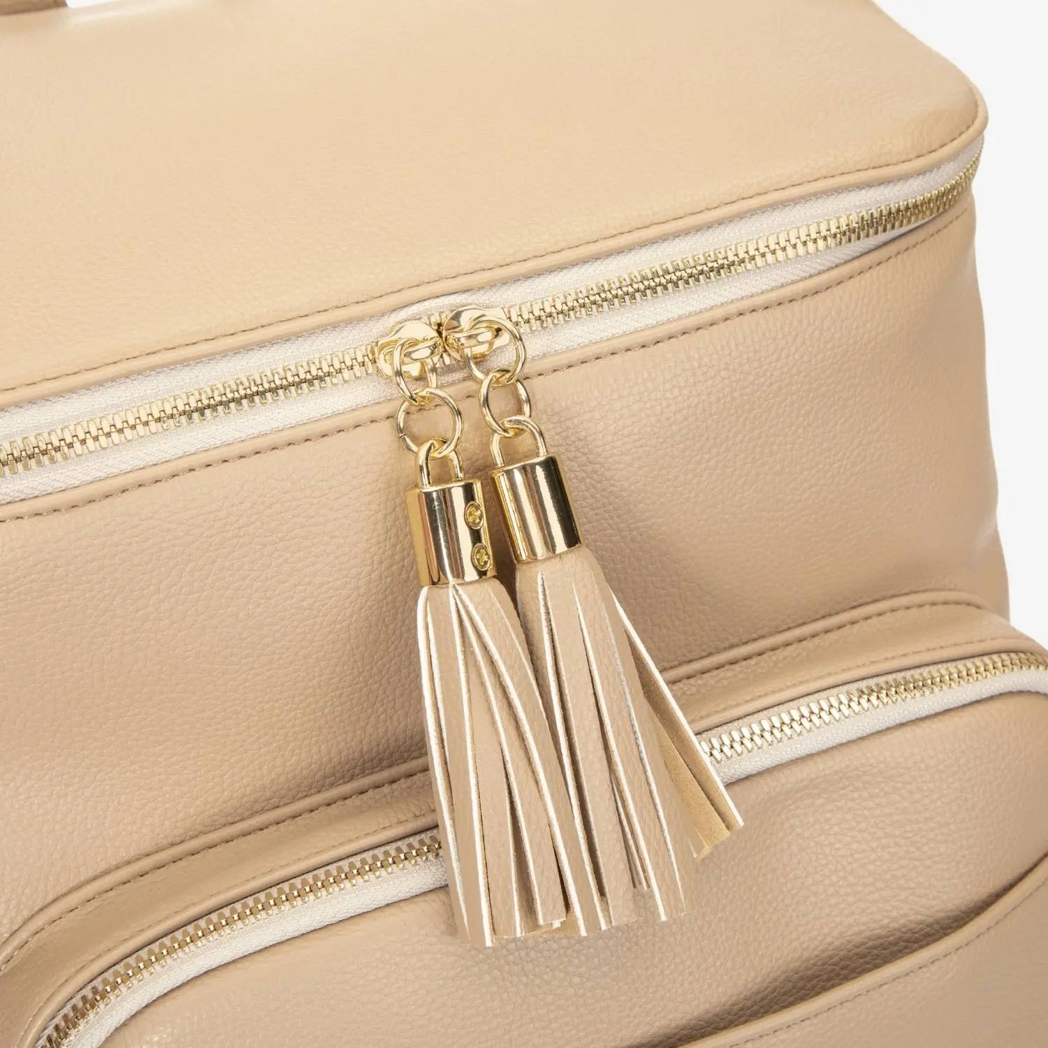 Gold hardware tassel on stone nappy bag backpack – close-up of fashionable and durable detail