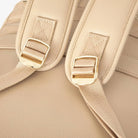 Tan nappy bag backpack strap hardware close-up featuring gold accents – elegant and sturdy design.