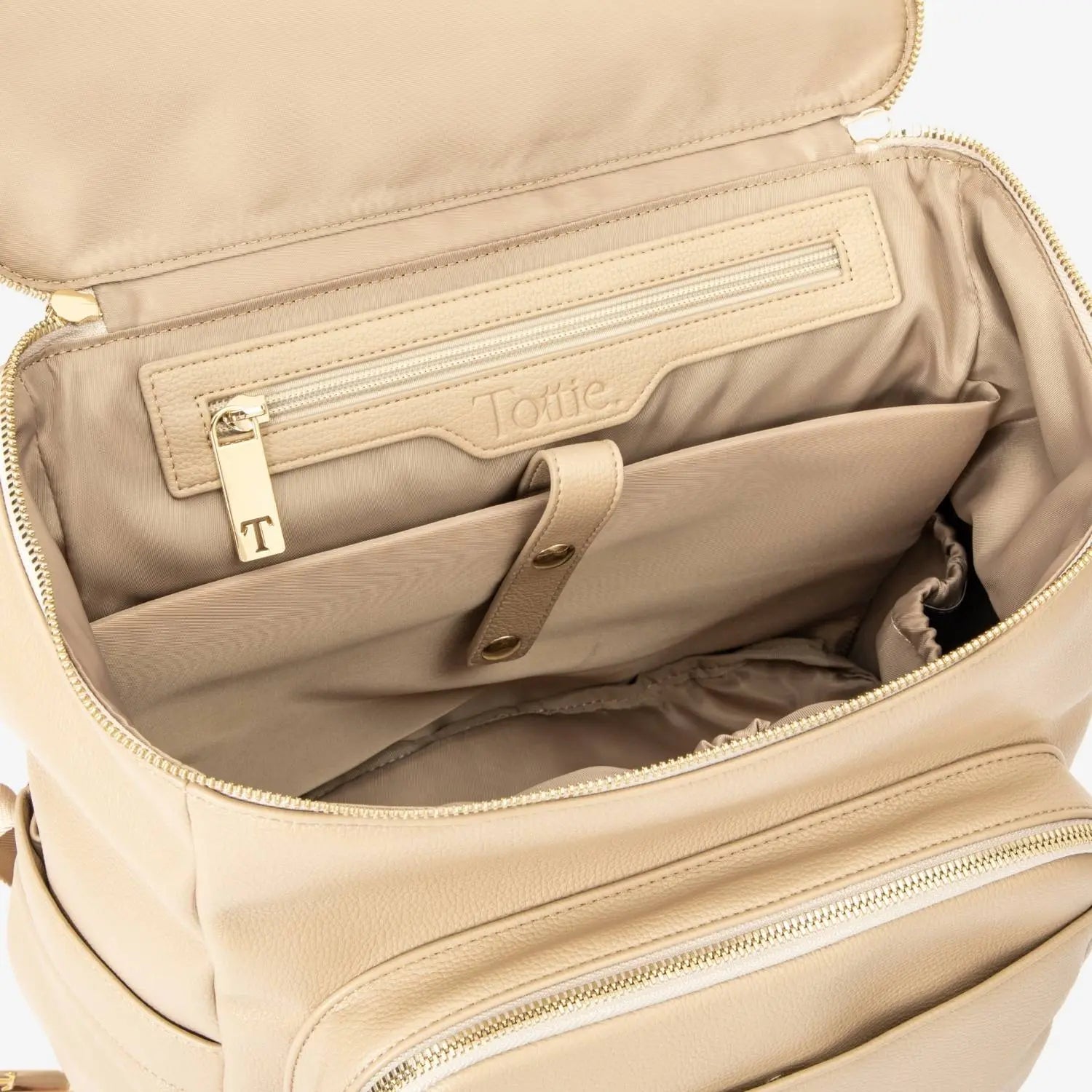 Open top view of stone nappy bag backpack featuring gold hardware – internal compartments for easy organisation.