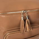 Stylish tassel on tan nappy bag backpack with gold hardware – perfect for Australian mums seeking elegance.