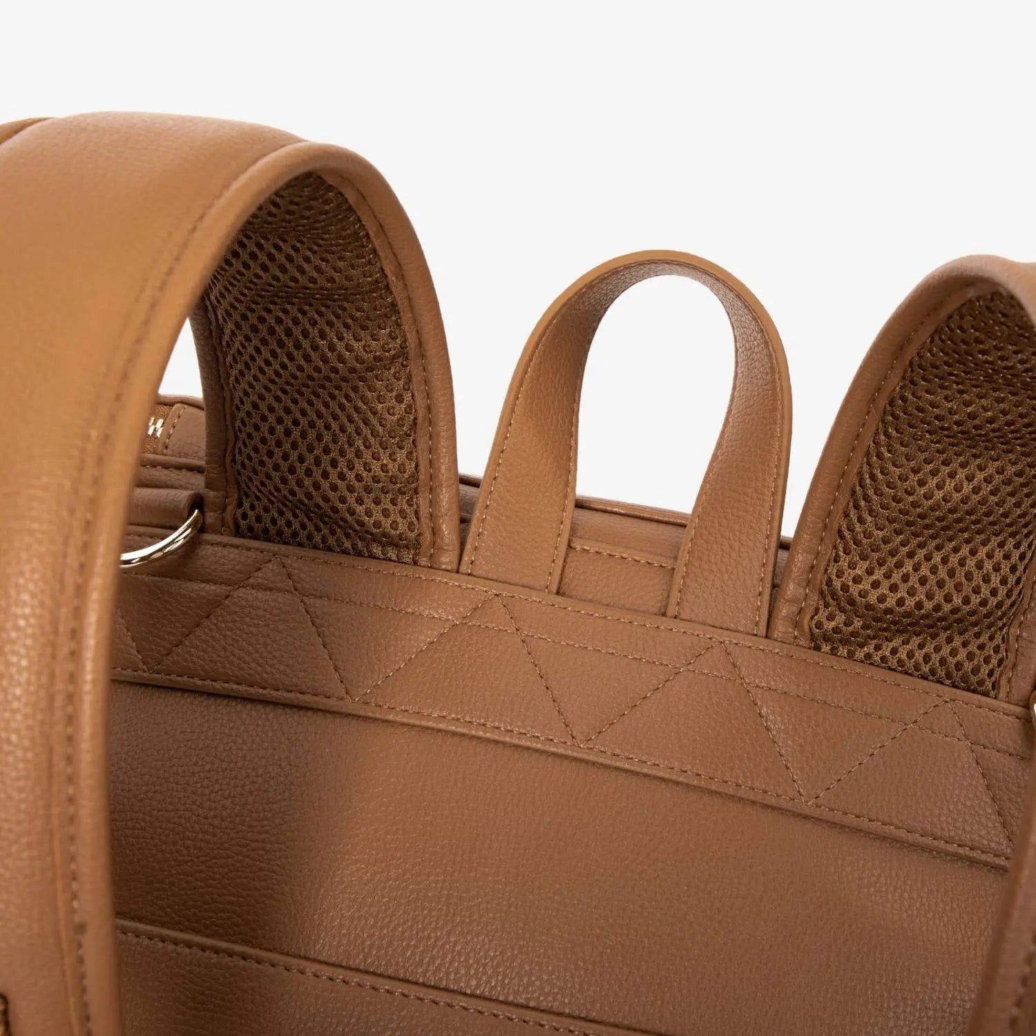 Close-up of tan nappy bag backpack handle – sturdy and comfortable grip for easy carrying.
