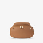 Bottom view of tan nappy bag backpack with gold hardware – sturdy base with protective feet for durability