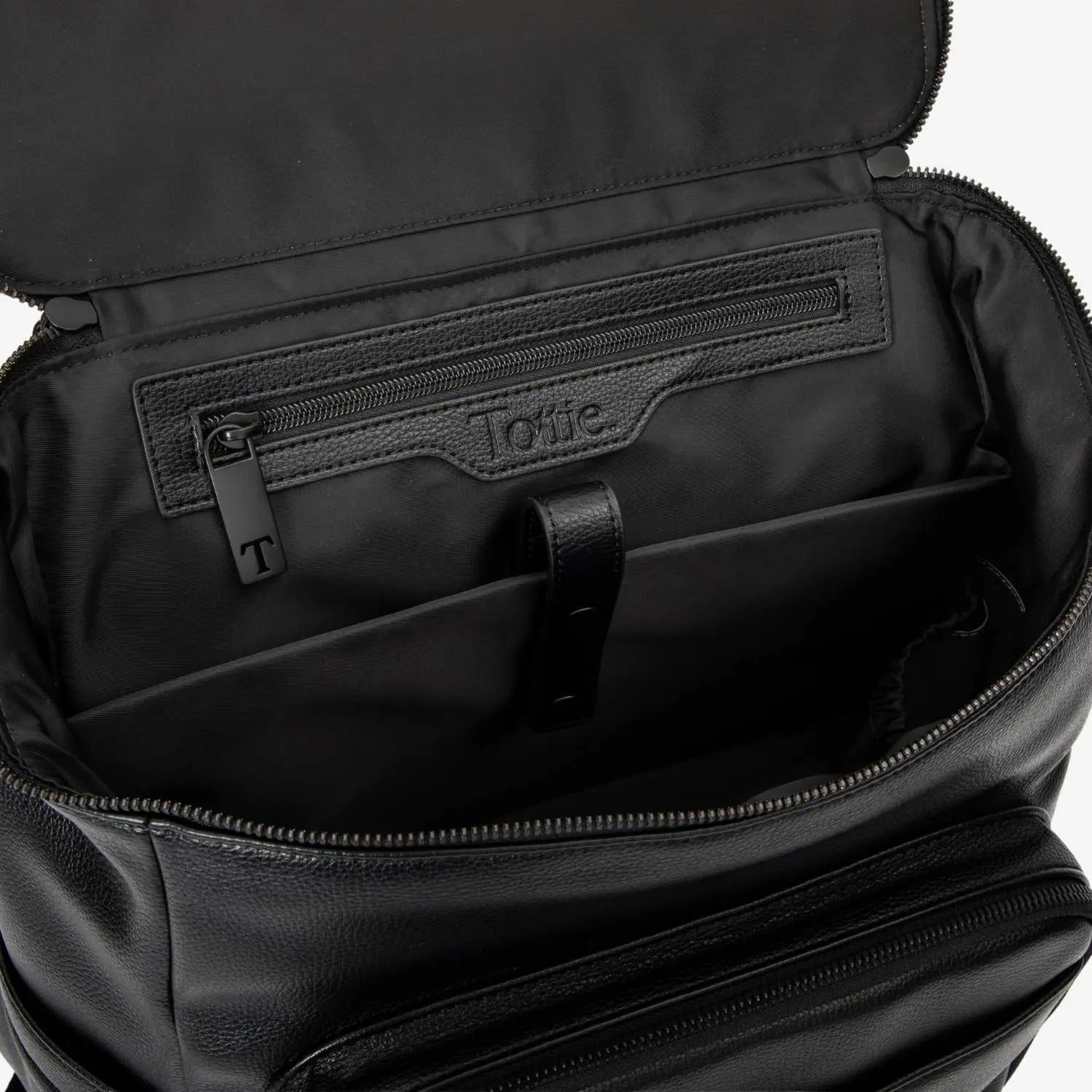 Open black nappy bag backpack with black hardware top view – organised compartments visible.