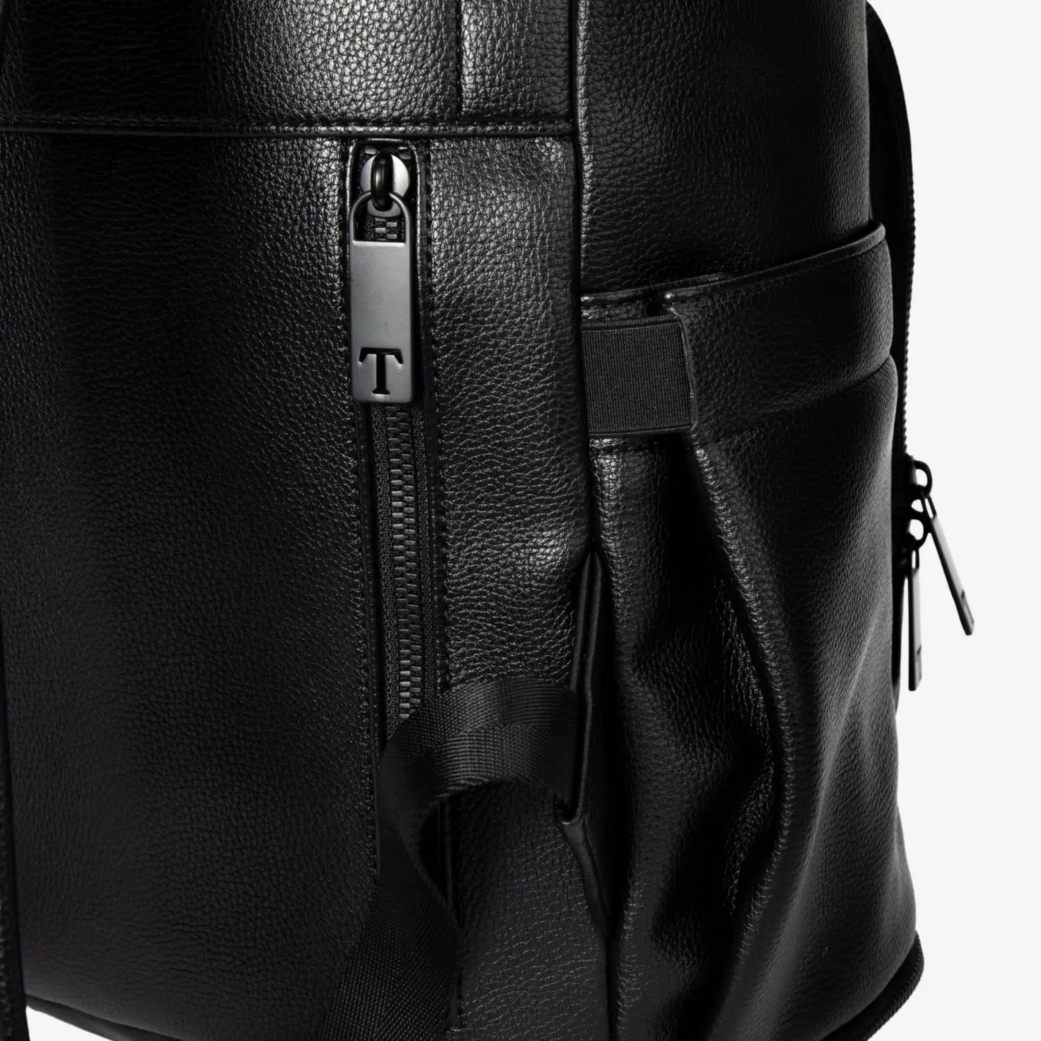 Side view close-up of zipper on black nappy bag backpack with black hardware – sleek and durable design.
