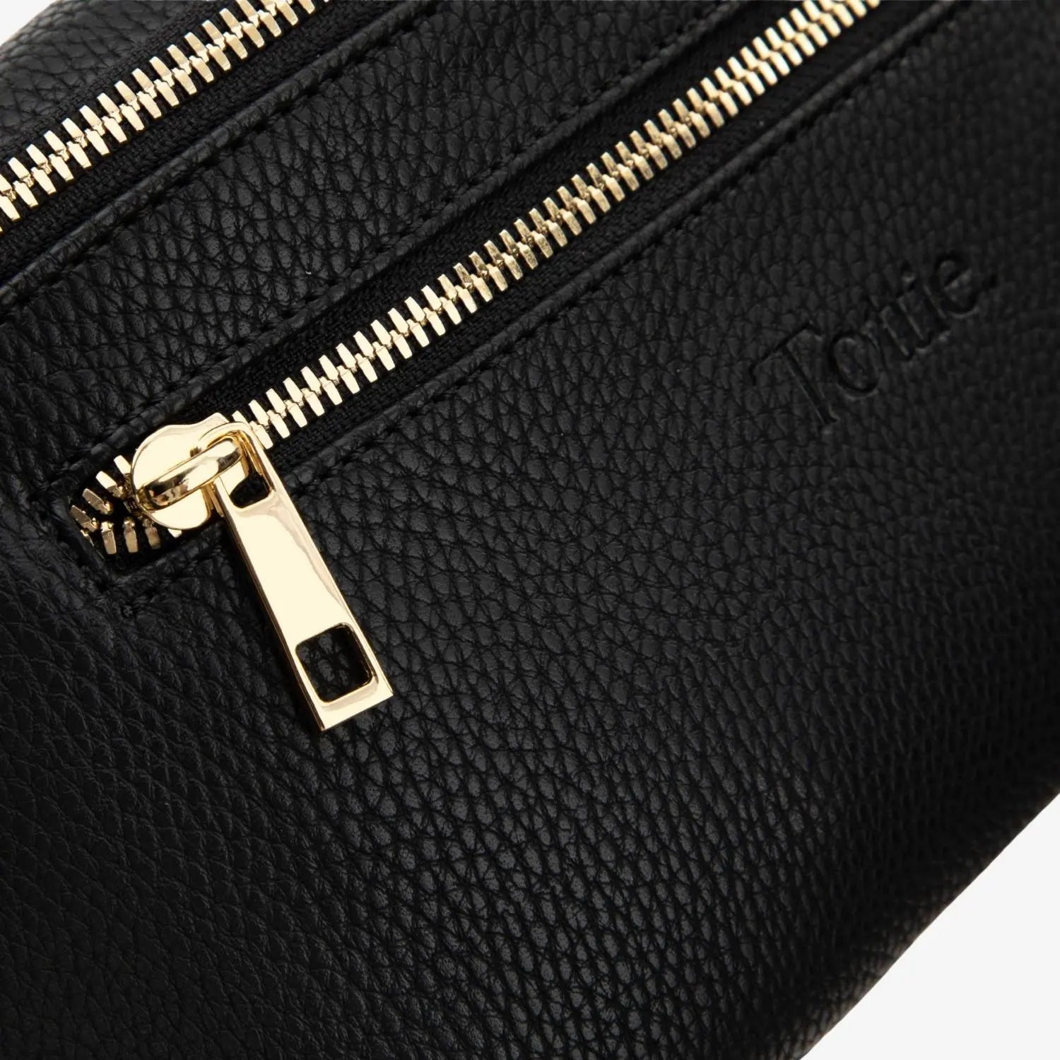 Black bum bag close-up featuring luxe gold zipper – perfect blend of functionality and fashion