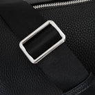 Detailed view of black bum bag showing polished silver hardware and sturdy black strap