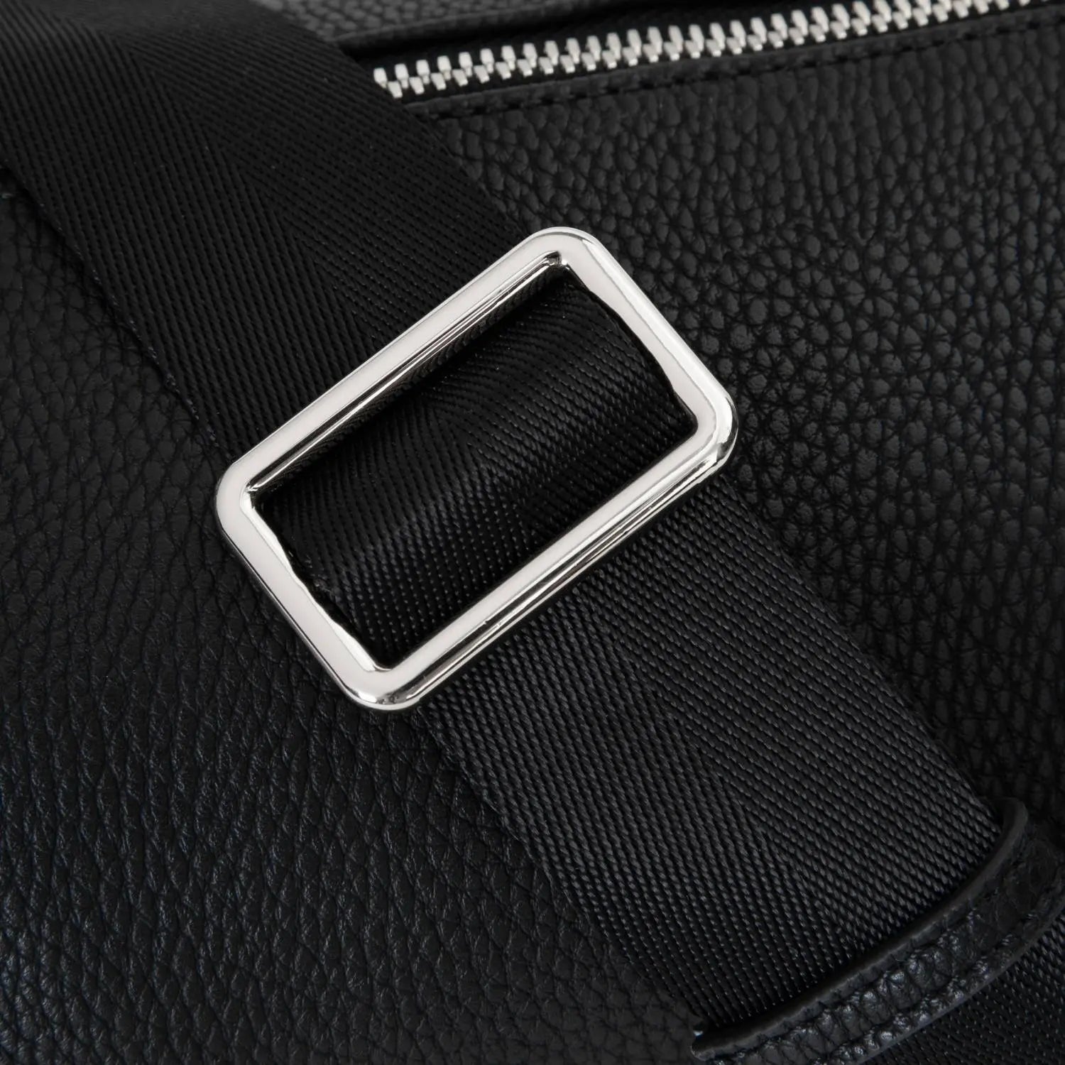 Detailed view of black bum bag showing polished silver hardware and sturdy black strap