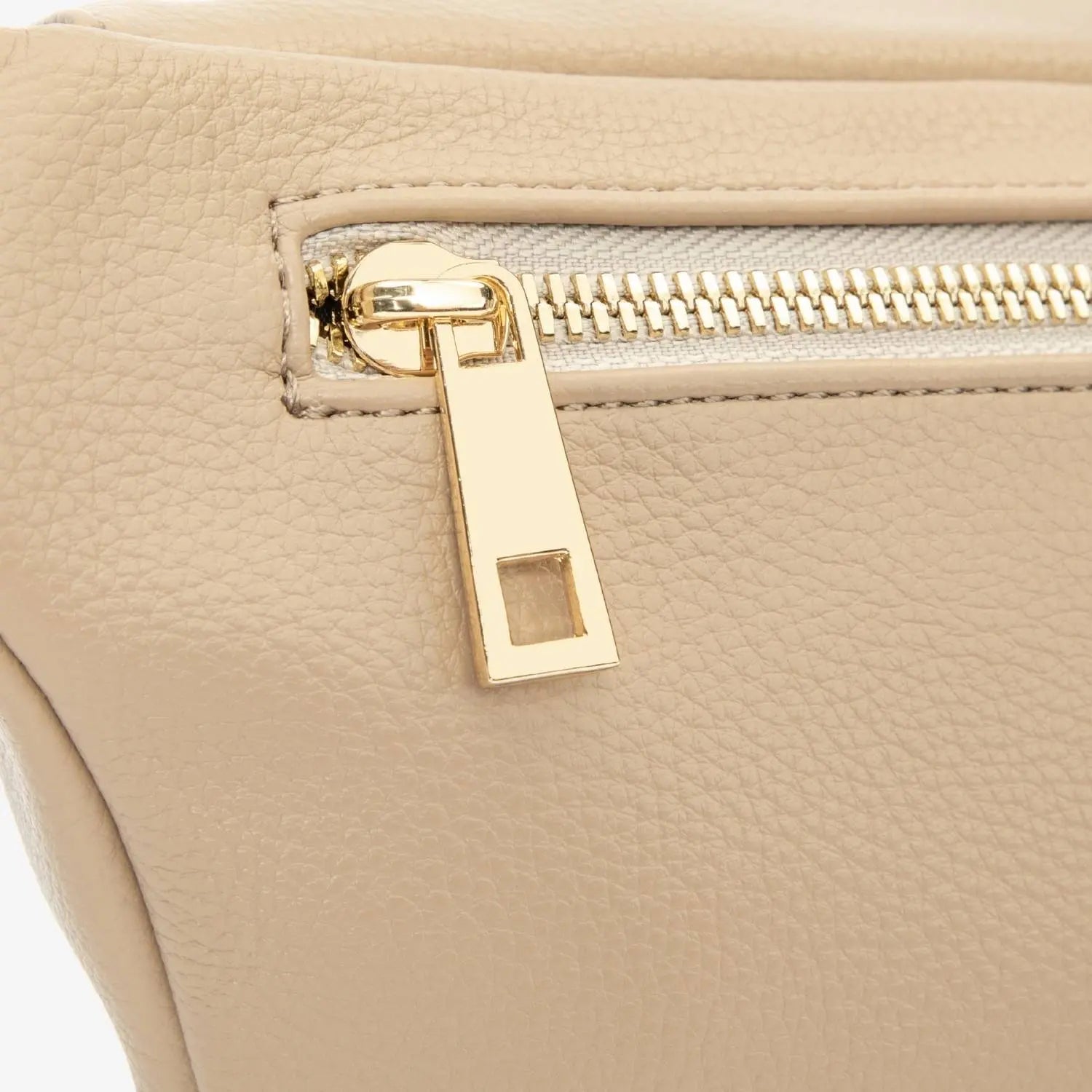 Gold zipper detail on stone-coloured bum bag – close-up showcasing high-quality hardware.