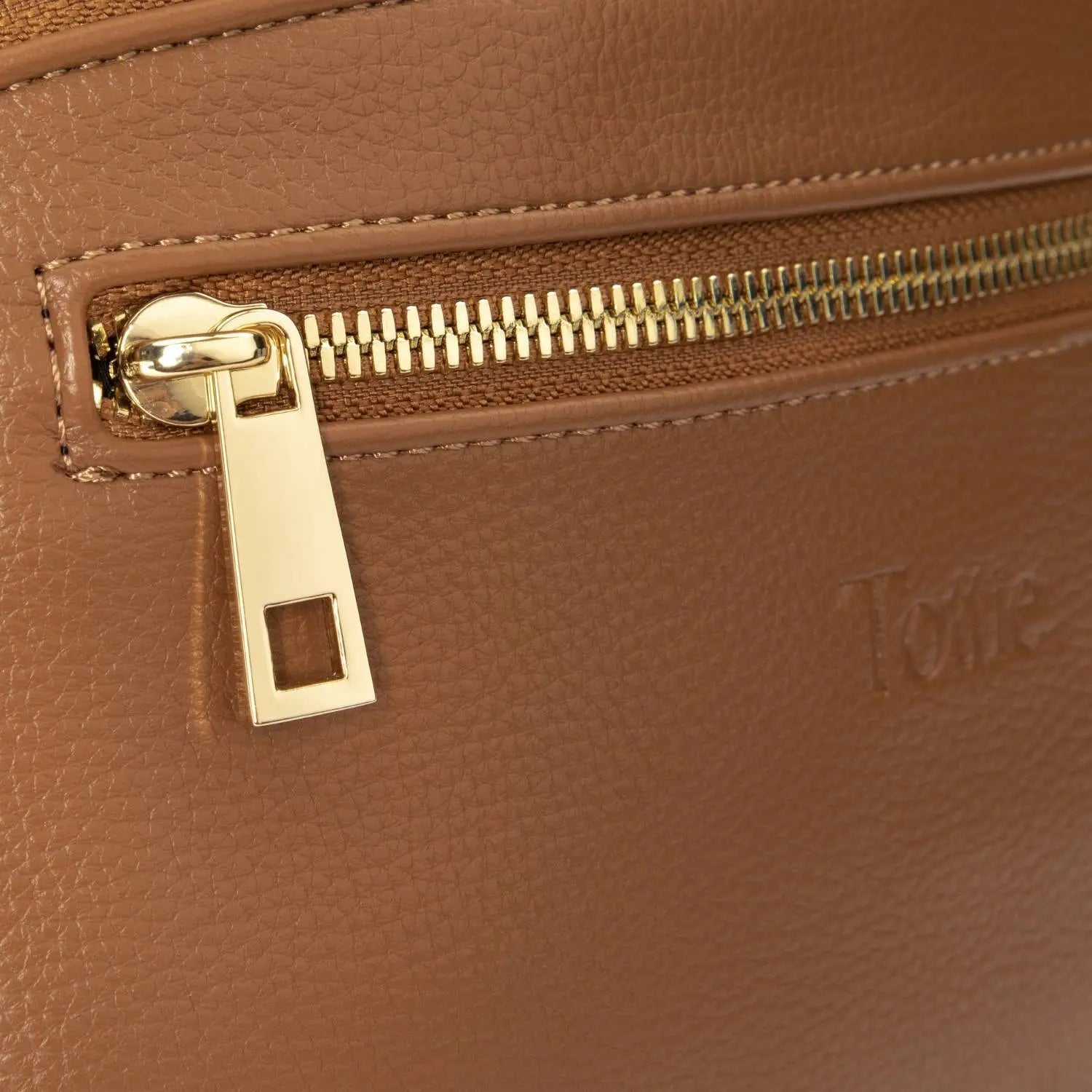 Close-up detailed view of gold zipper on tan bum bag – sleek and durable hardware