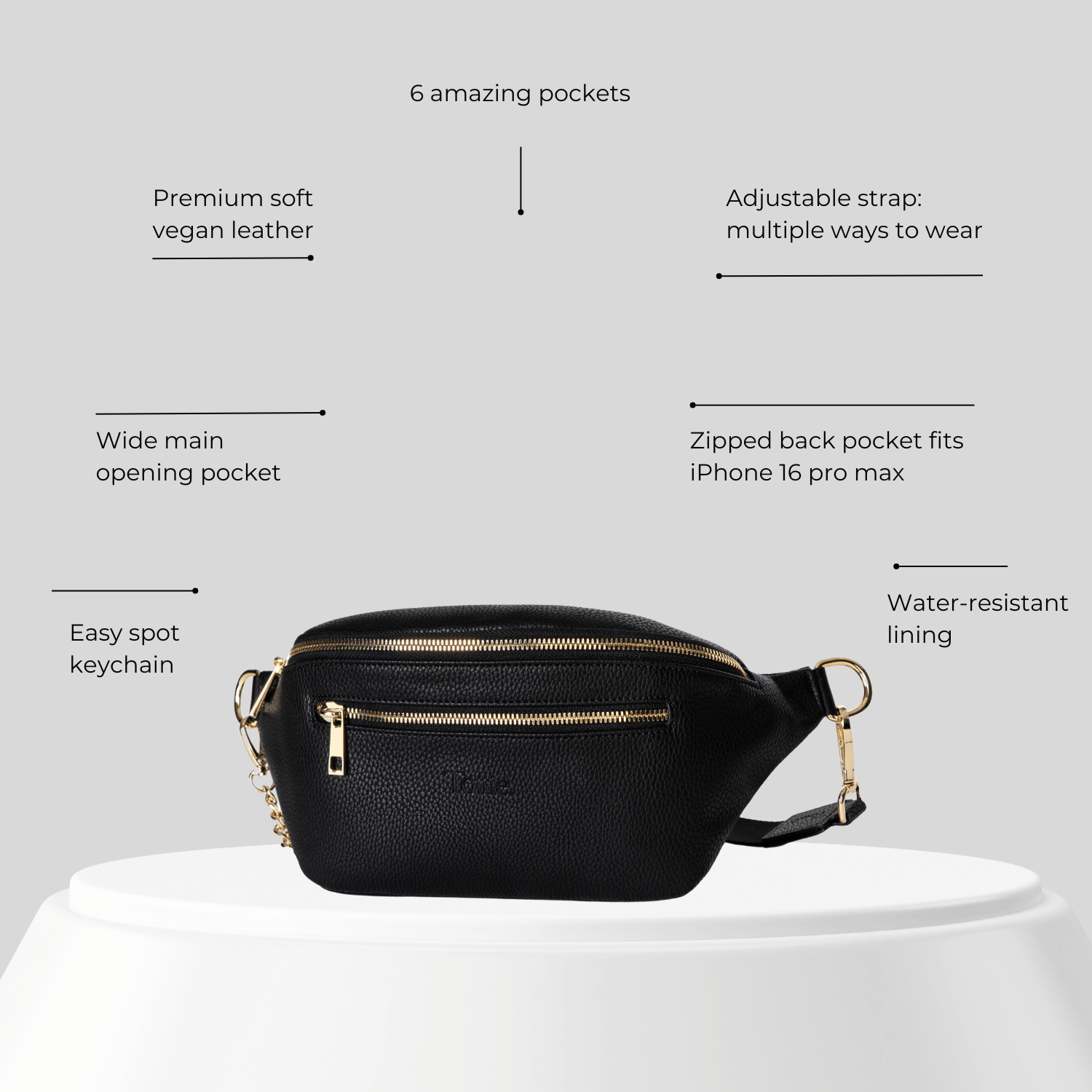 Black vegan leather belt bag with features listed on a gray background