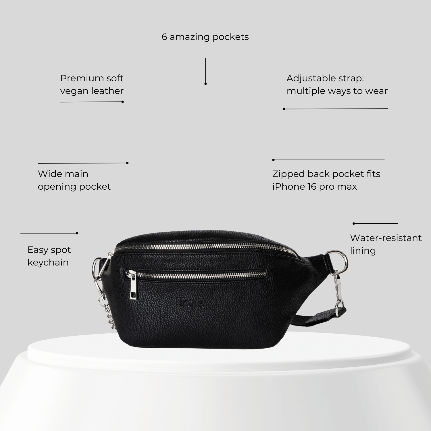 Black vegan leather belt bag with features listed on a gray background