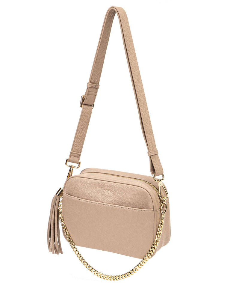 stone colored leather crossbody bag in white background