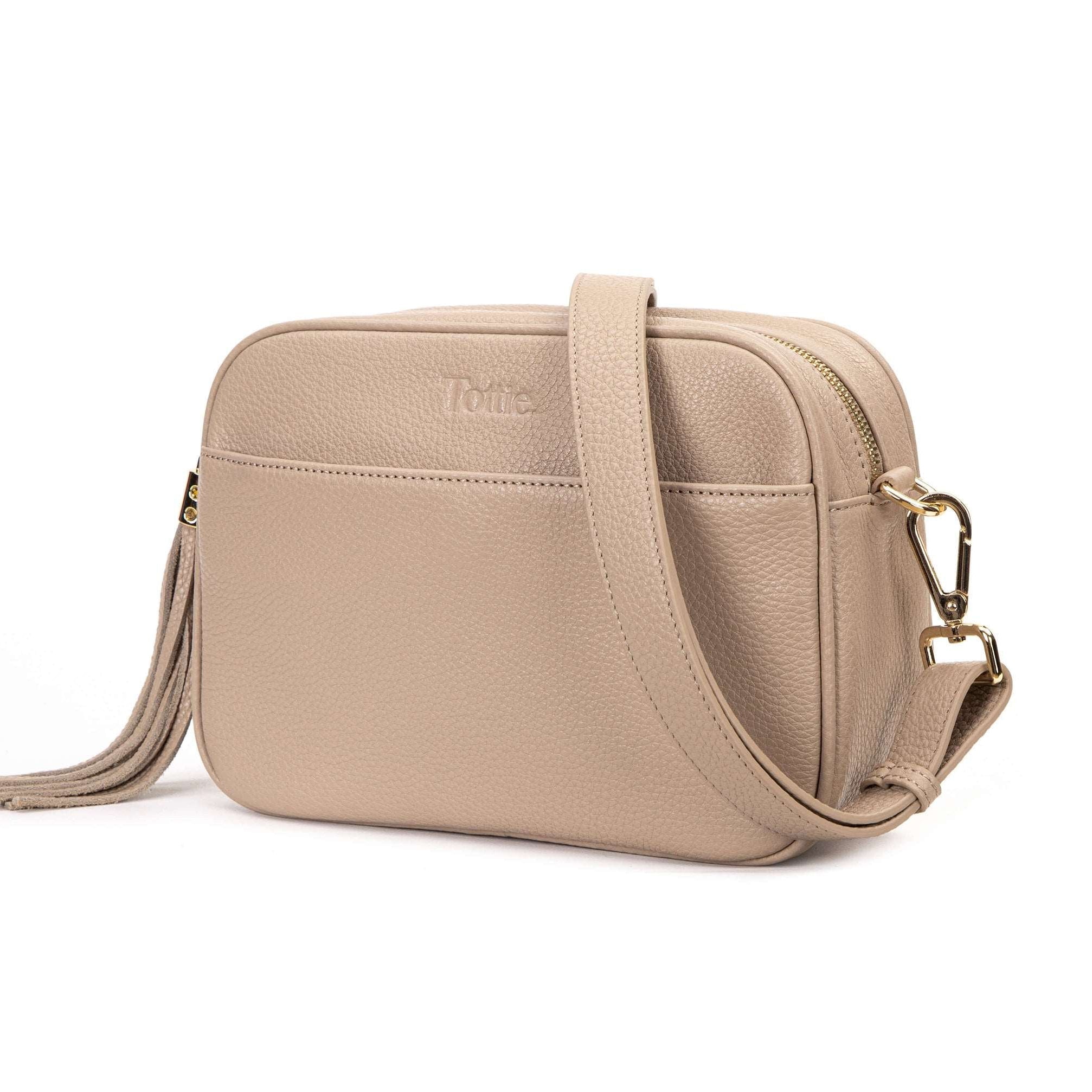 stone colored leather crossbody bag in white background