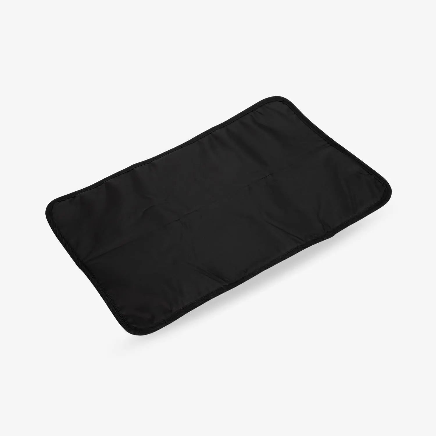 Black change mat with matte black hardware laid flat on a white surface – minimalist and practical baby essential.