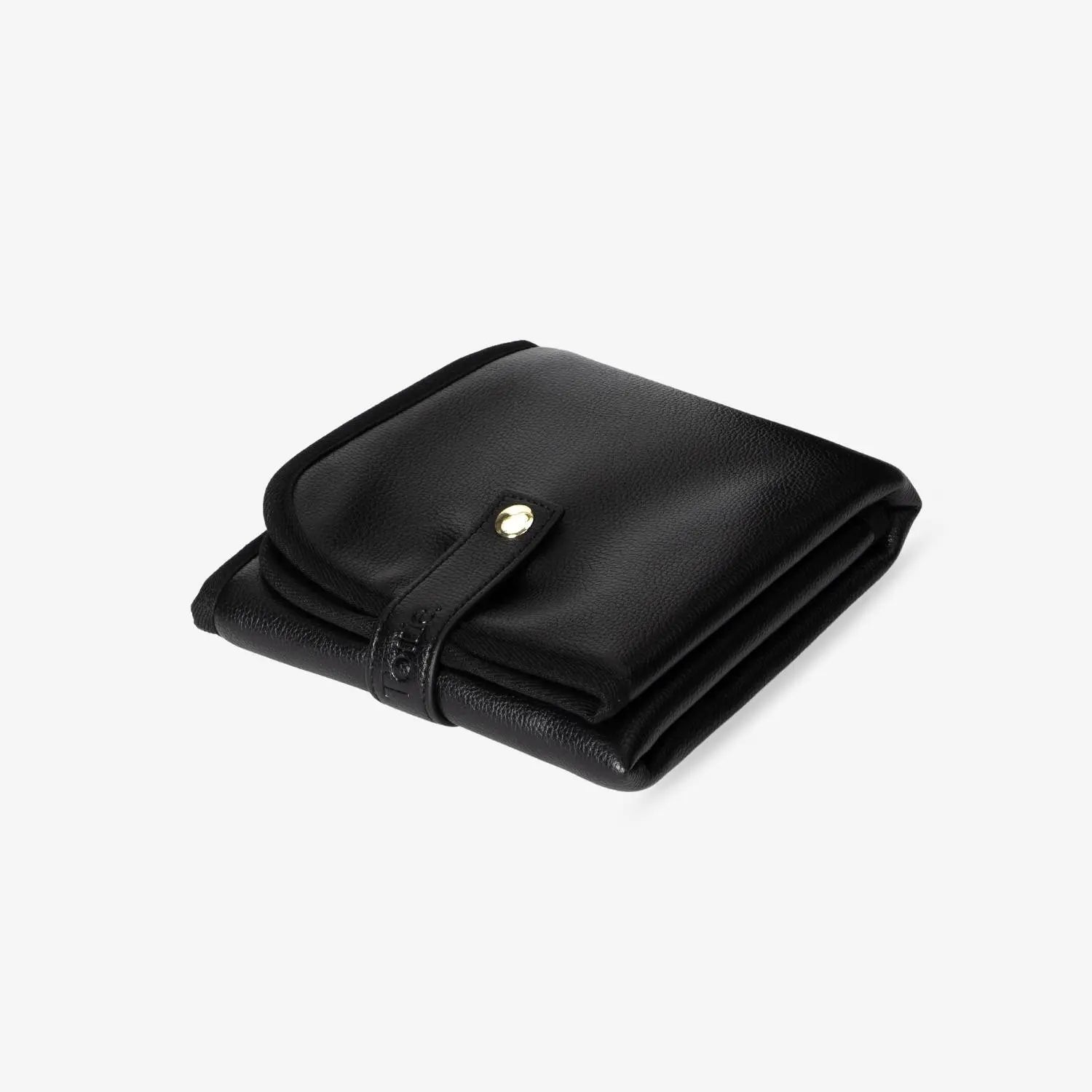 Folded black change mat with gold hardware, photographed against a white background – likely highlighting portability, design, and finishes.