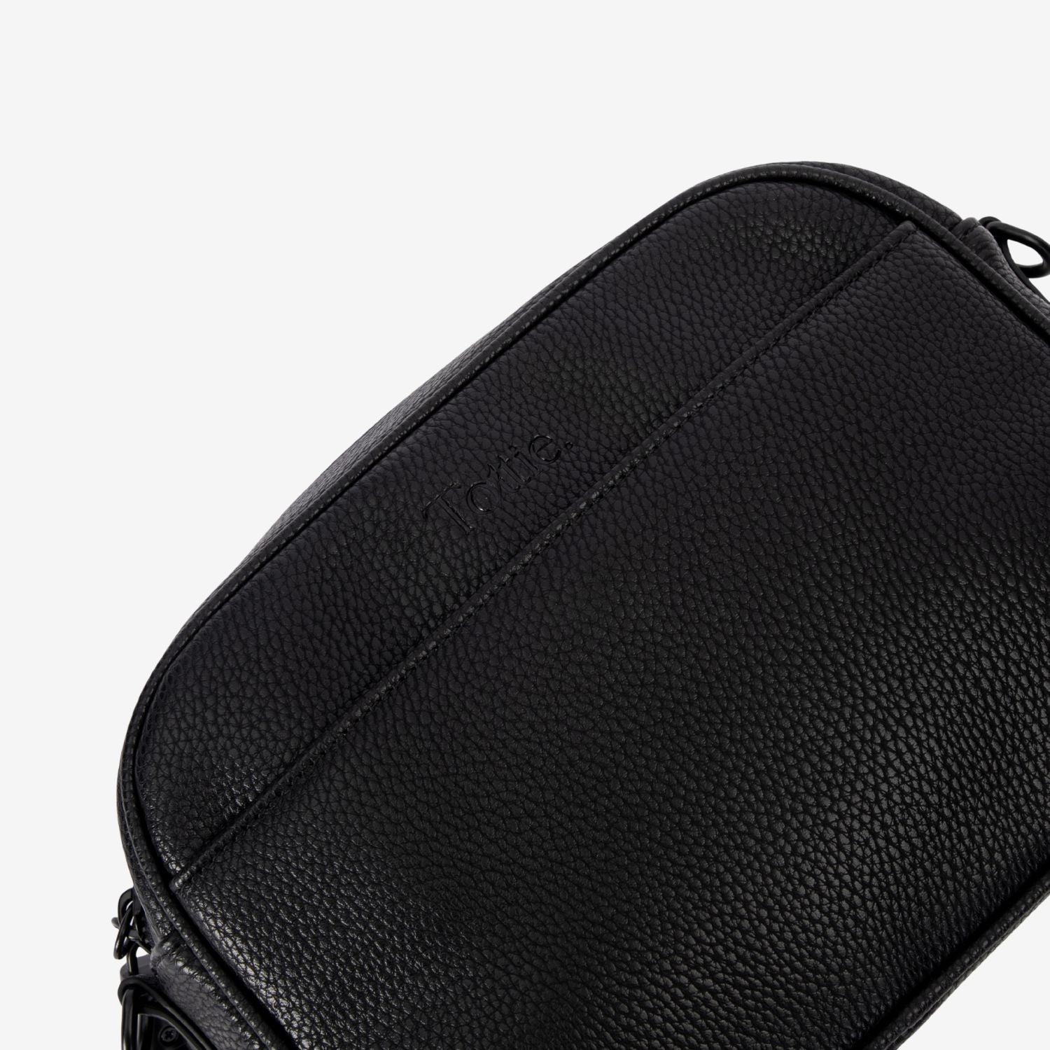 Black leather crossbody bag with a textured surface on a white background