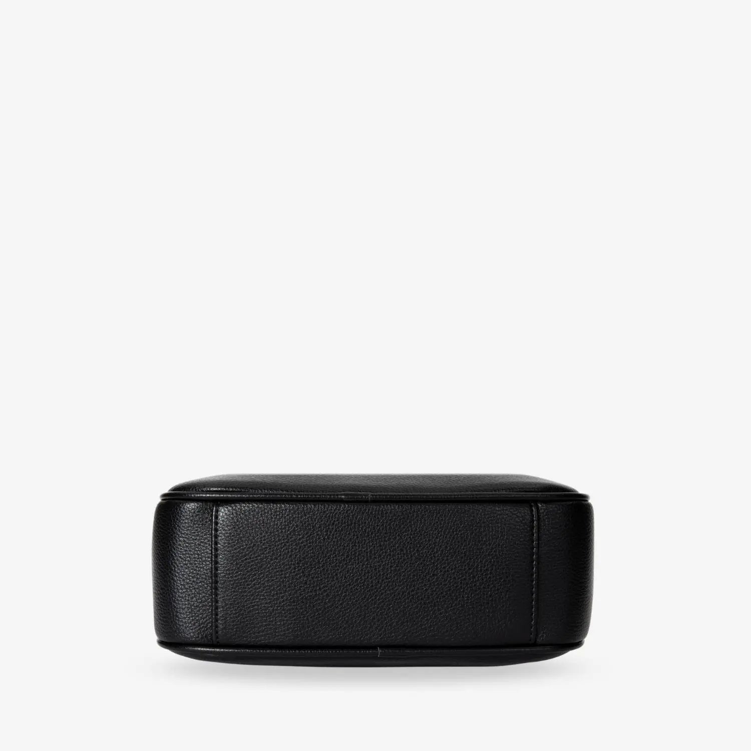 Black crossbody bag base featuring durable black hardware – detailed shot of structured bottom