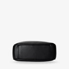 Detailed bottom shot of black crossbody bag with gold hardware accents – sleek accessory feature