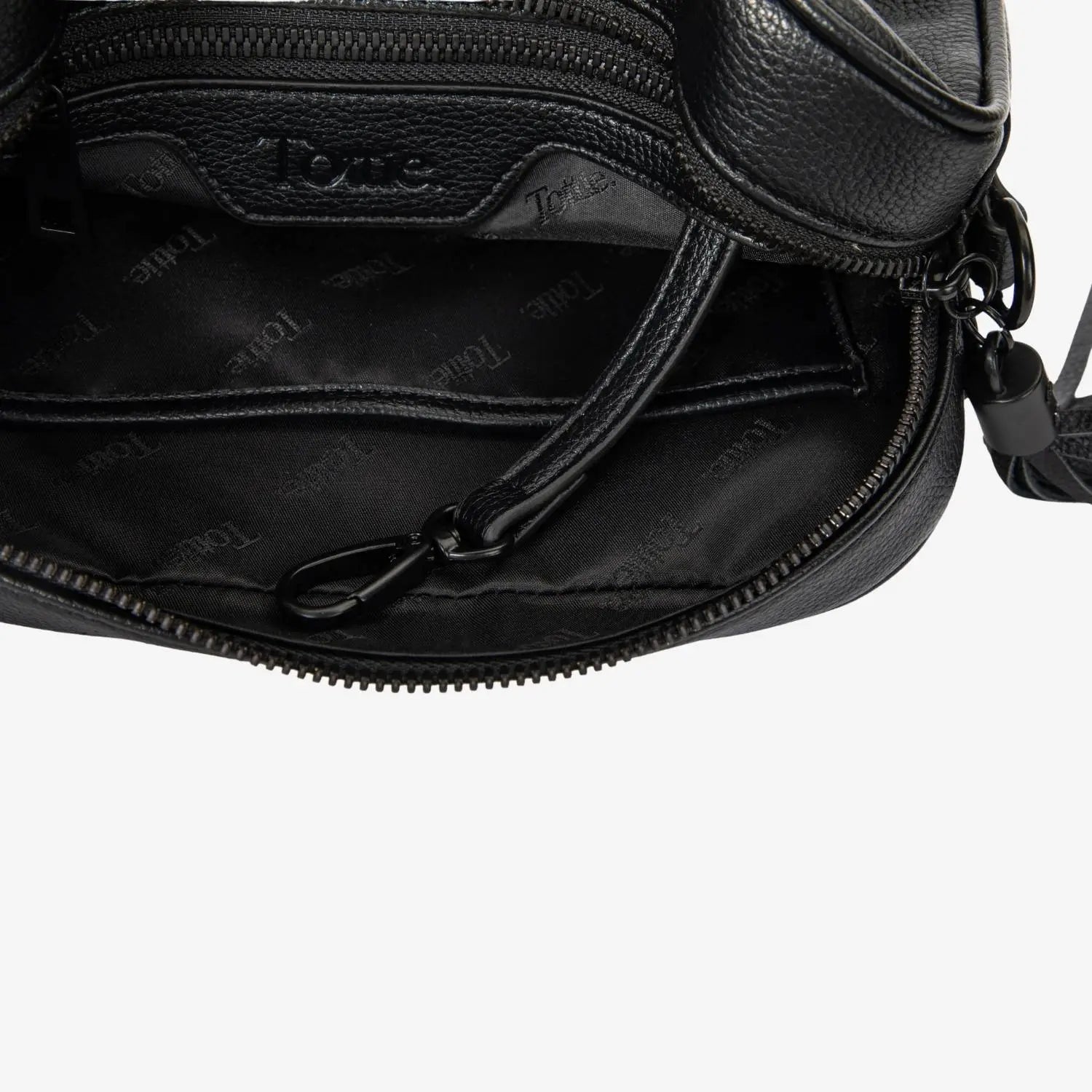Detailed interior view of black crossbody bag with black hardware and visible Tottie logo embossed inside
