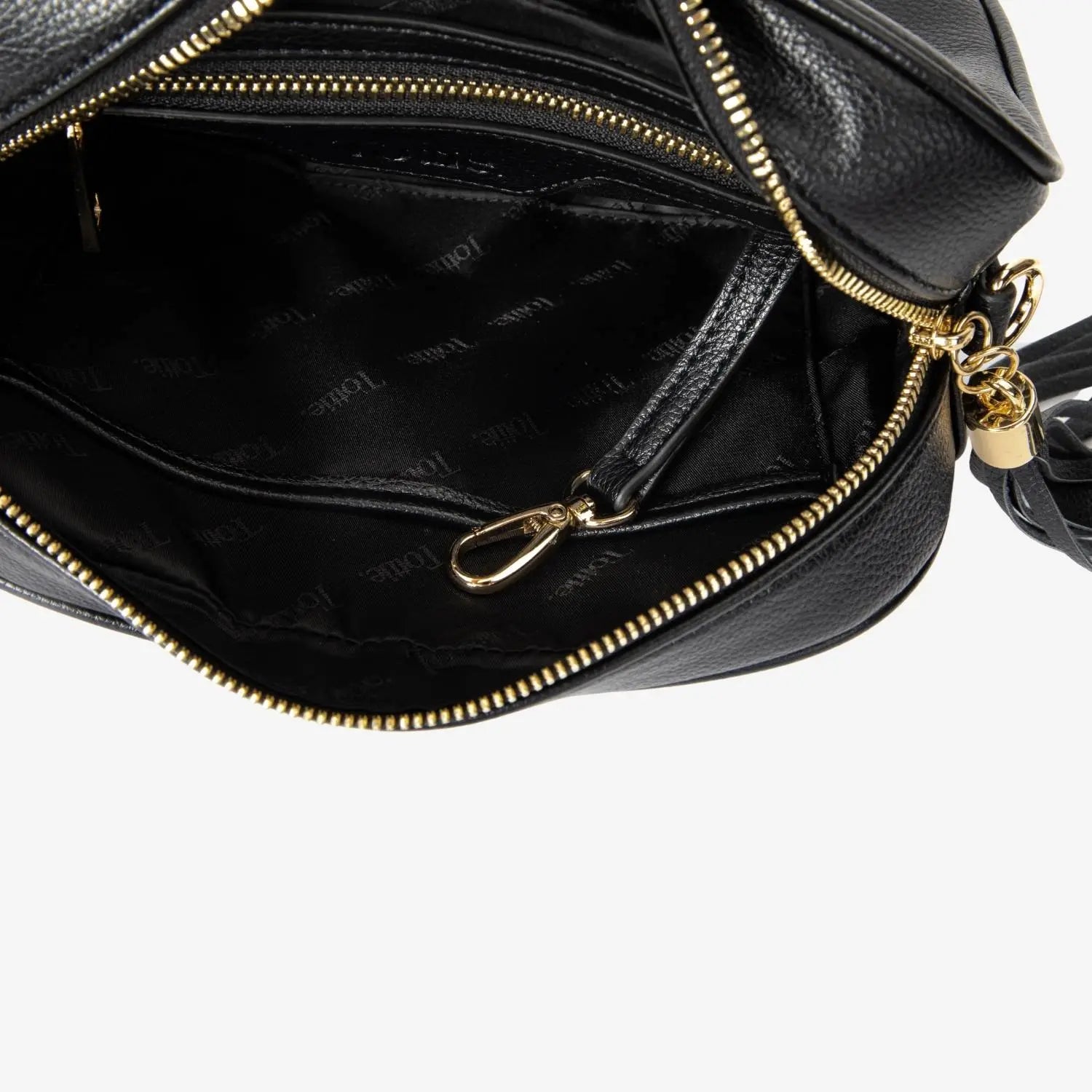 Close-up of open black crossbody bag with gold hardware showing embossed Tottie logo inside