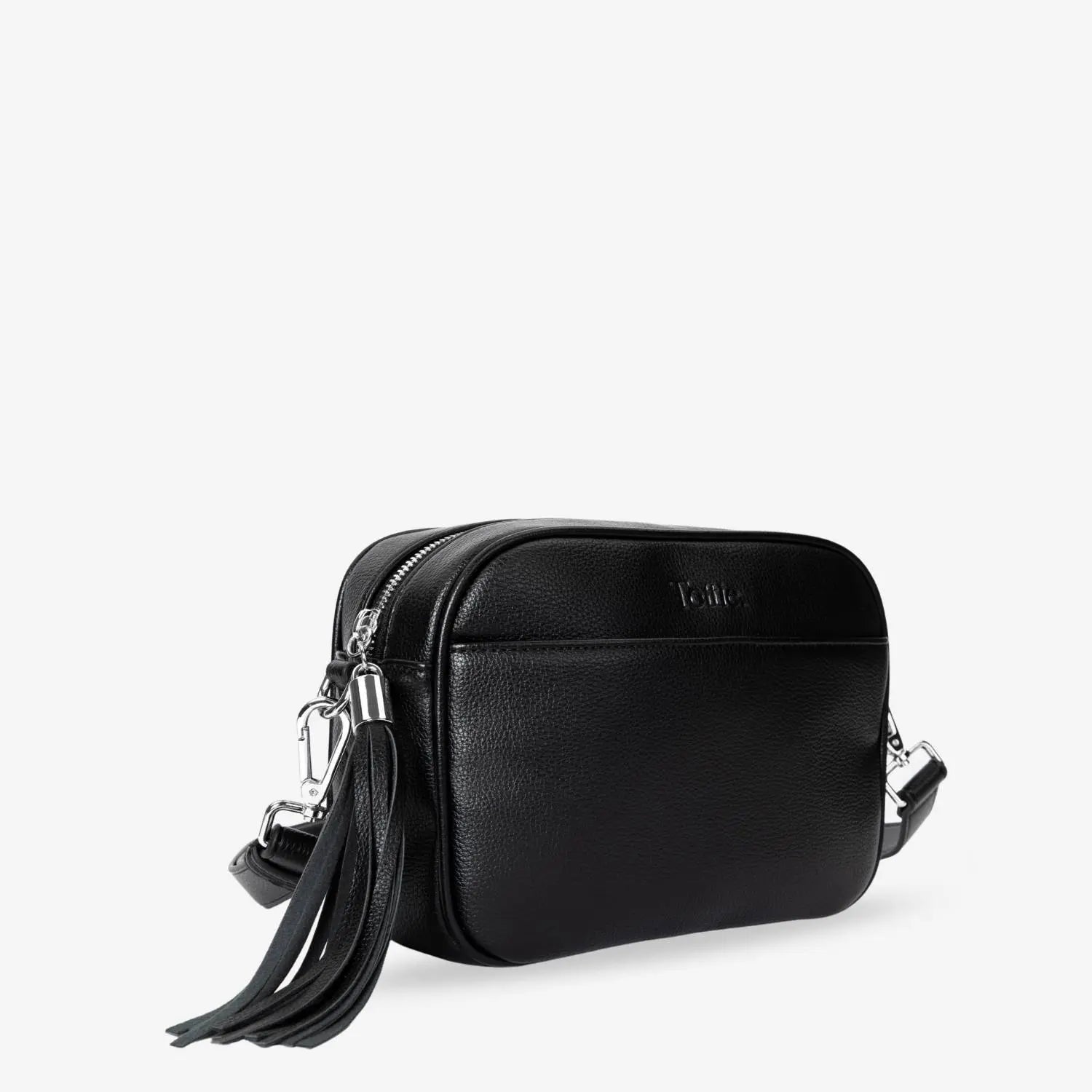 Modern black crossbody bag with contrasting silver hardware captured in slight side view.