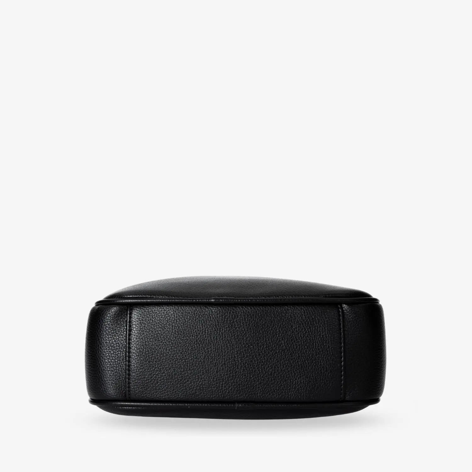 Black crossbody bag bottom showing silver-tone hardware accents and sturdy design.