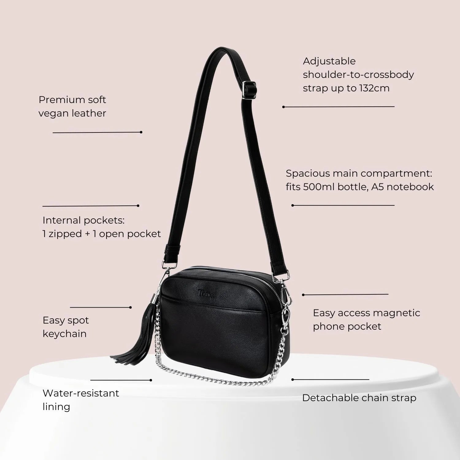 Black crossbody bag with silver hardware and labelled features like zip pockets, adjustable strap, and sleek design.