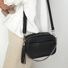 Close look at crossbody bag with sleek silver hardware and quality stitching.