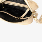 Open stone colour crossbody bag with gold hardware showing interior compartments on white backdrop