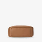 Detailed bottom shot of tan colour crossbody bag with gold hardware on white background