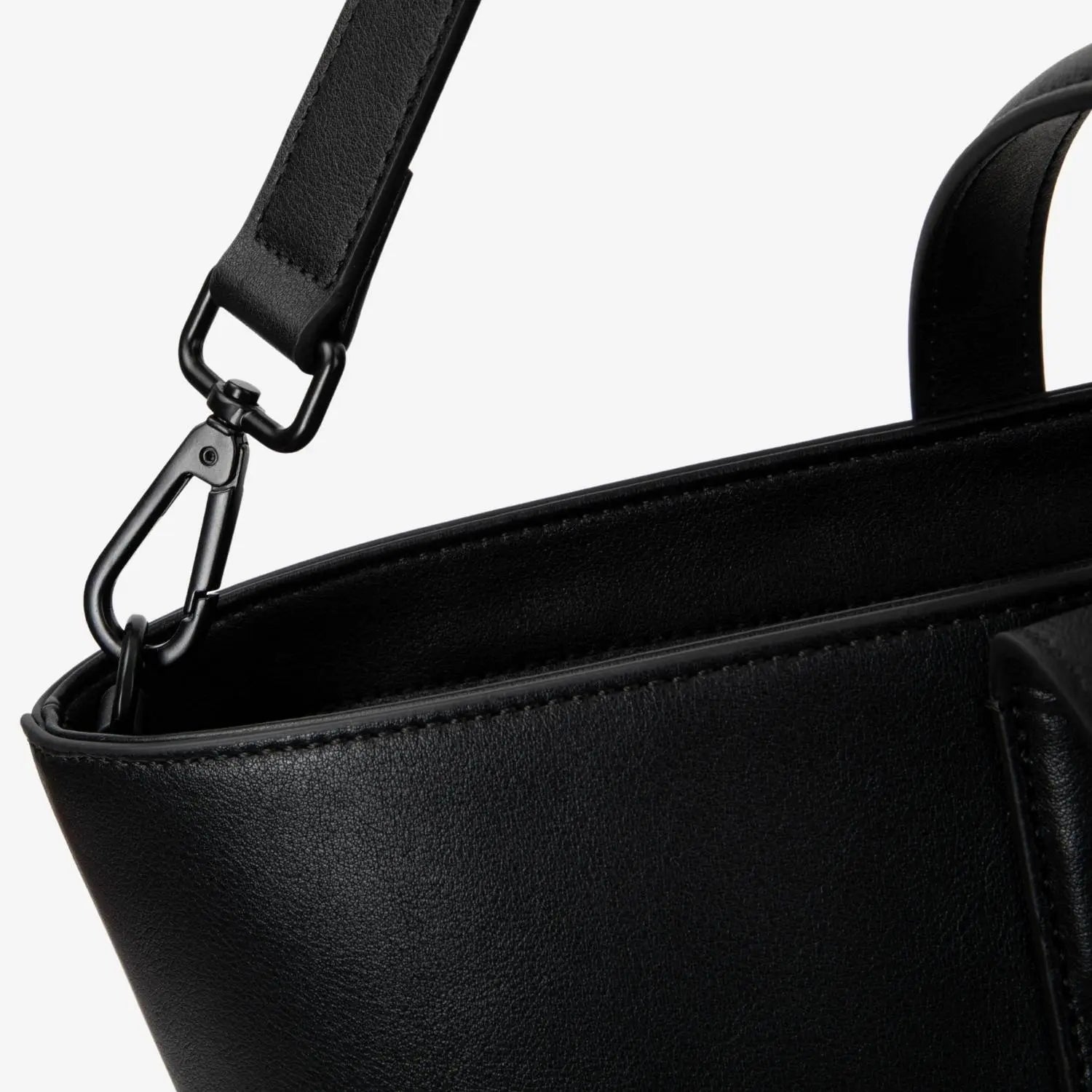 Black colour tote bag hardware close-up showing polished metal finish and design