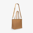 Slightly angled view of tan tote bag highlighting texture and craftsmanship