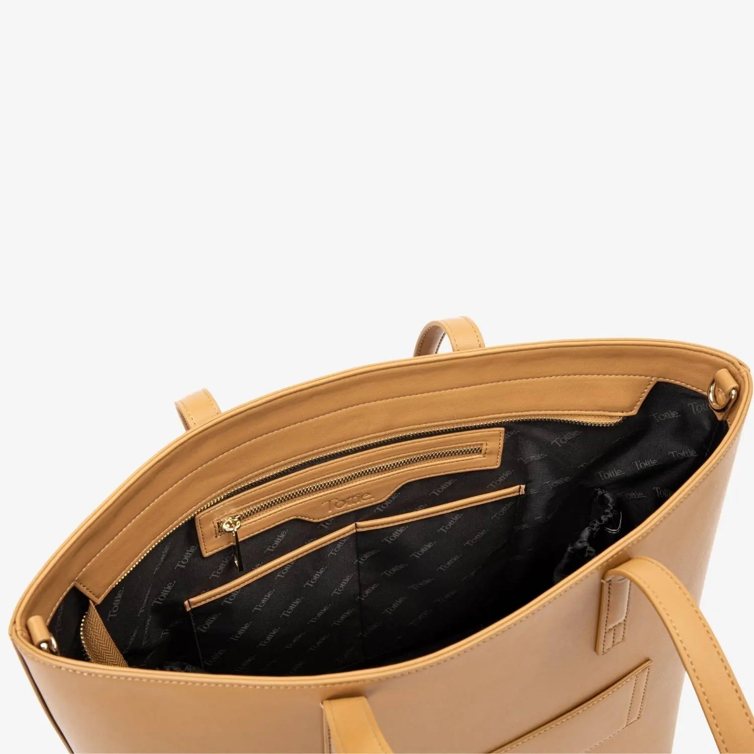 Spacious interior of tan colour tote bag visible from top view, showing bag’s design.