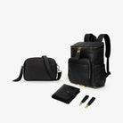 Black mama bundle with gold hardware, including nappy bag backpack, crossbody bag, baby change mat and pram clips on white background