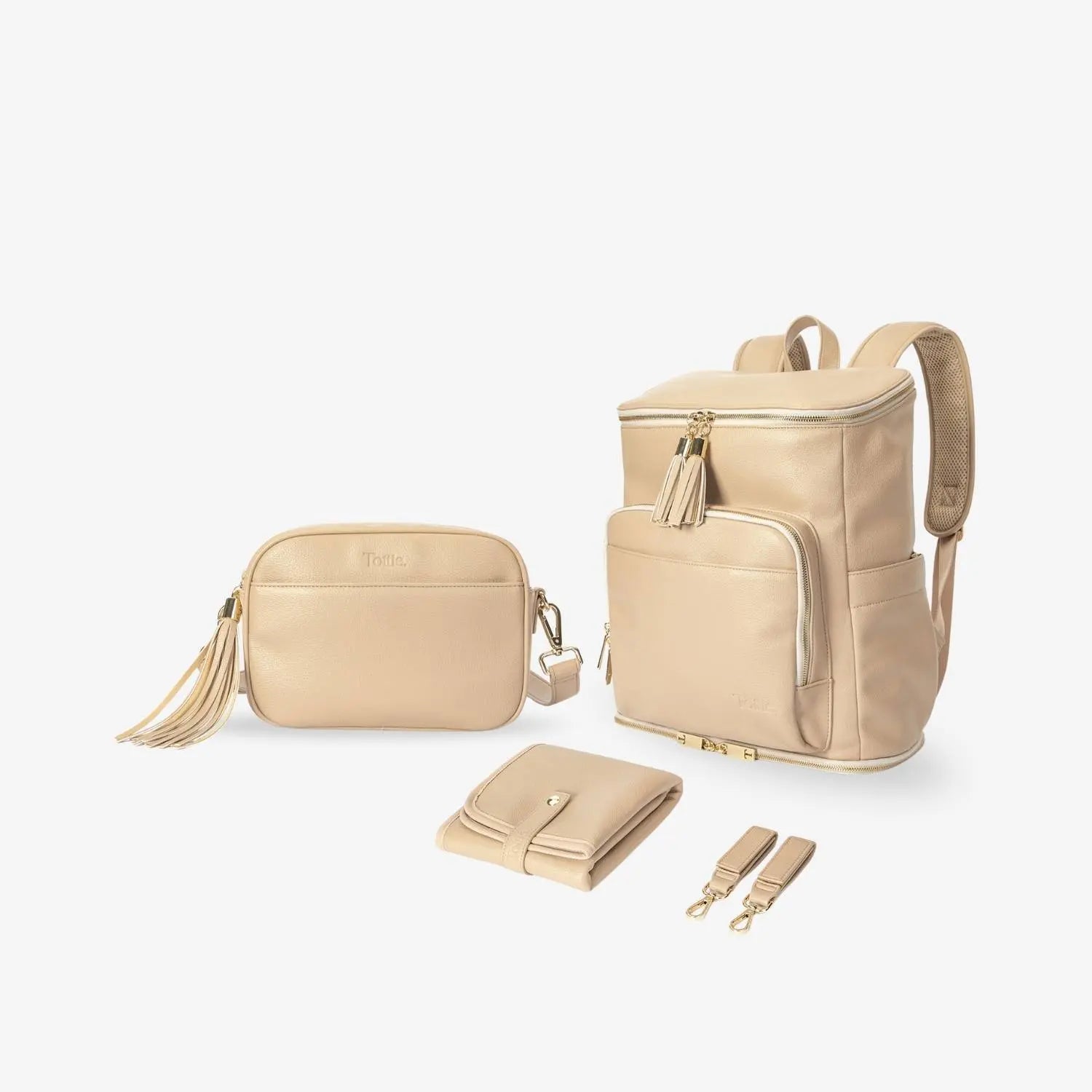 Complete Mama Bundle showing stone nappy bag backpack, crossbody bag, baby change mat, and pram clips with gold hardware on plain white background