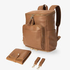 Tan nappy bag backpack with matching tan change mat and pram clips, all featuring elegant gold hardware – stylish and practical baby essentials