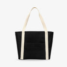 Straight-on front view of black nylon tote bag featuring cream strap, photographed on white background