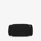 Bottom view of black nylon tote bag with cream strap on white background – structured and durable base.