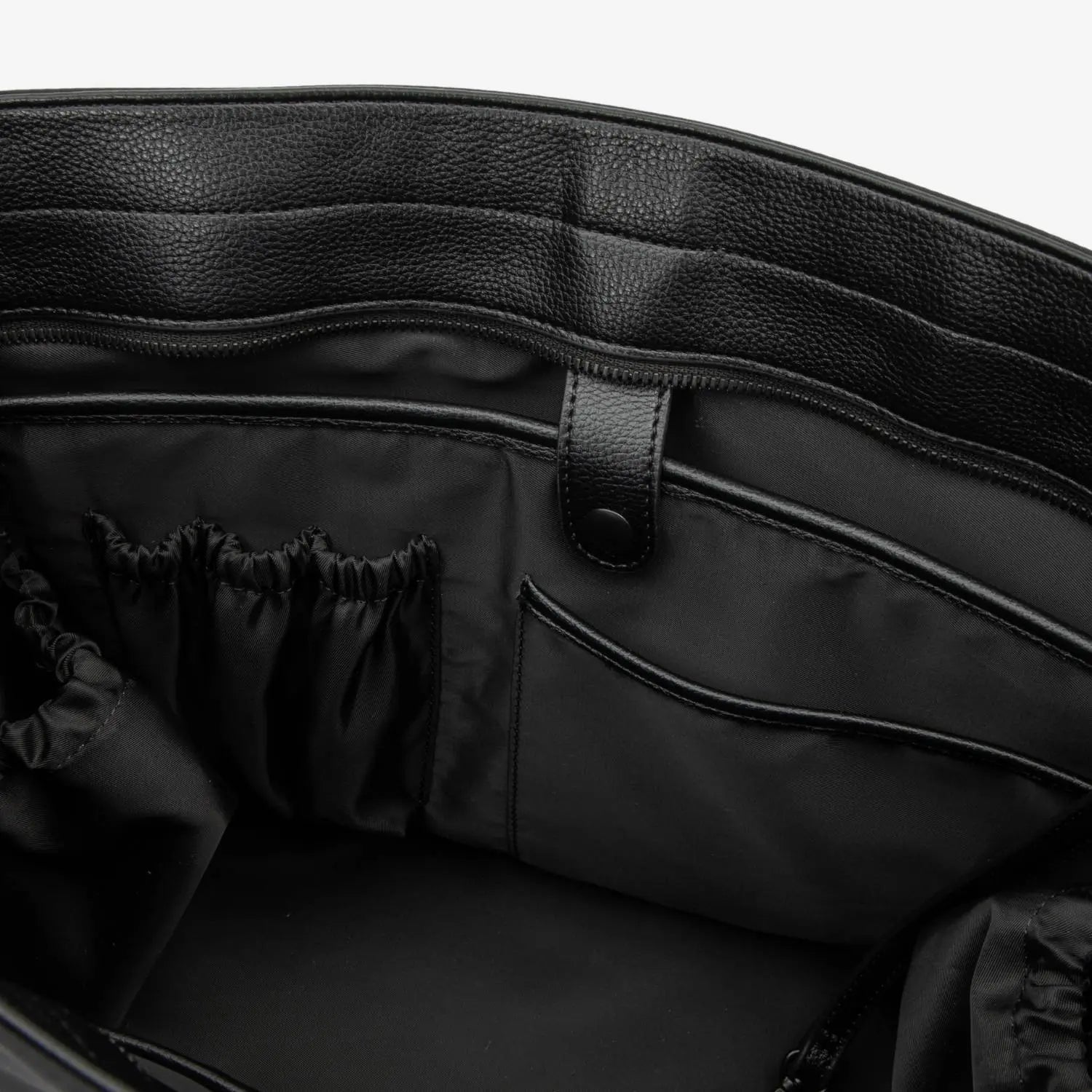 Closer look inside black nylon tote bag with cream strap, showing spacious interior.