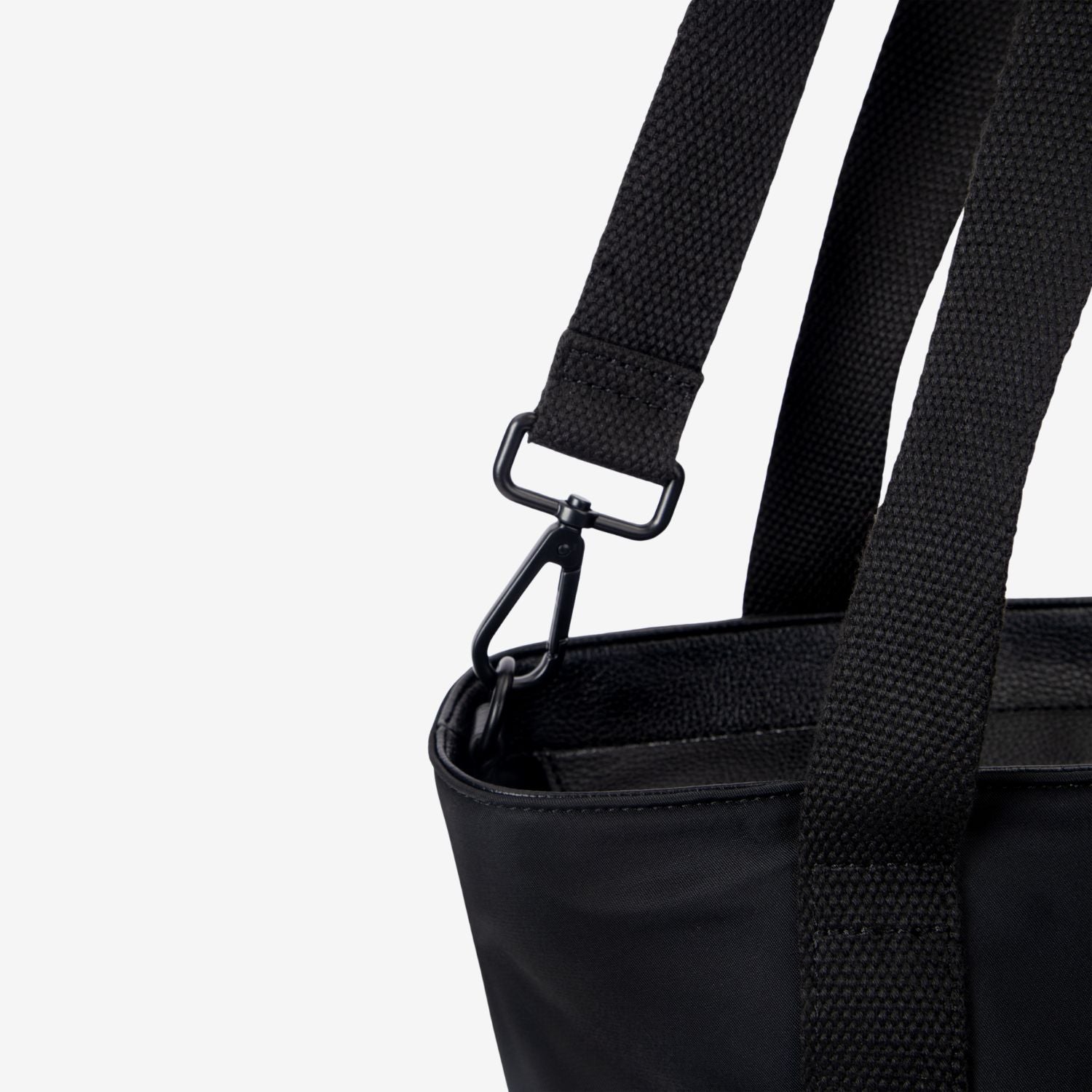 Close-up of a black nappy tote bag with a strap on a white background