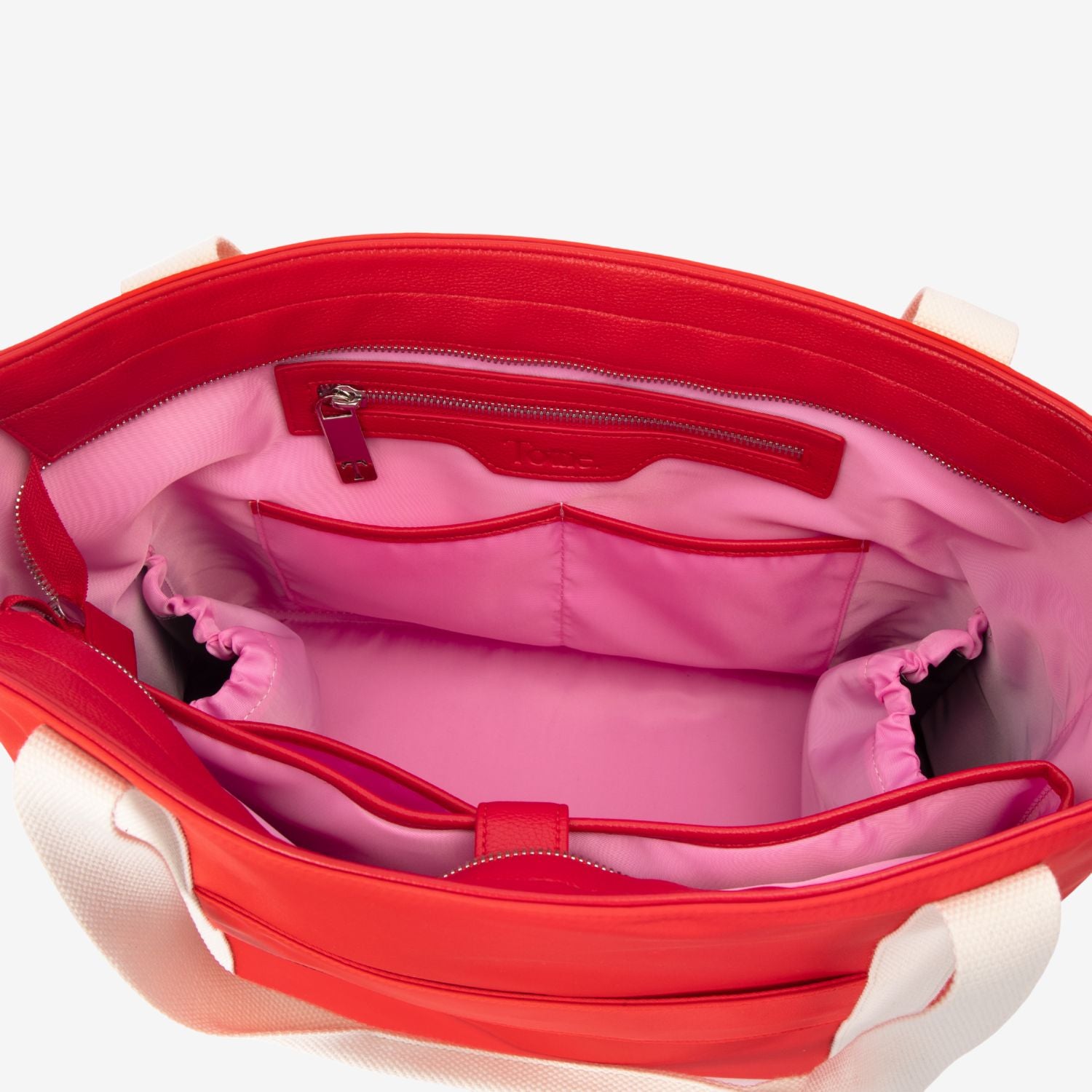Red tote bag with pink interior on a white background